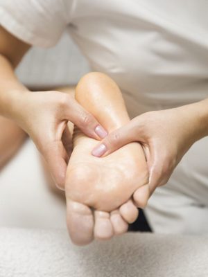 Closeup of the woman receiving foot massage in spa salon